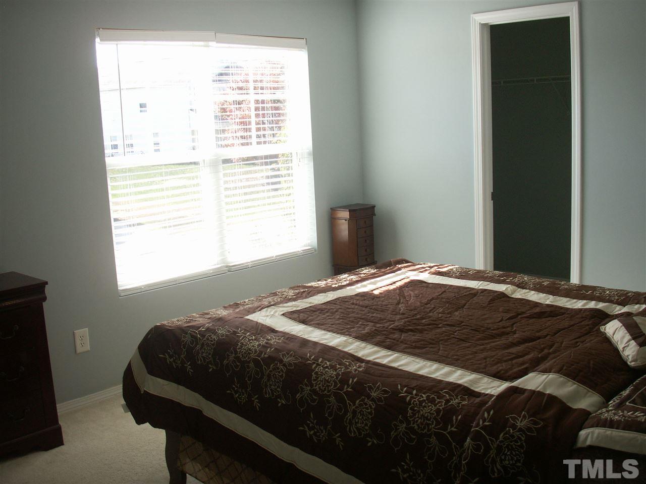 3129 Varcroft Road Knightdale, NC 27545 - Photo 21 of 25 a bedroom with a bed and a window