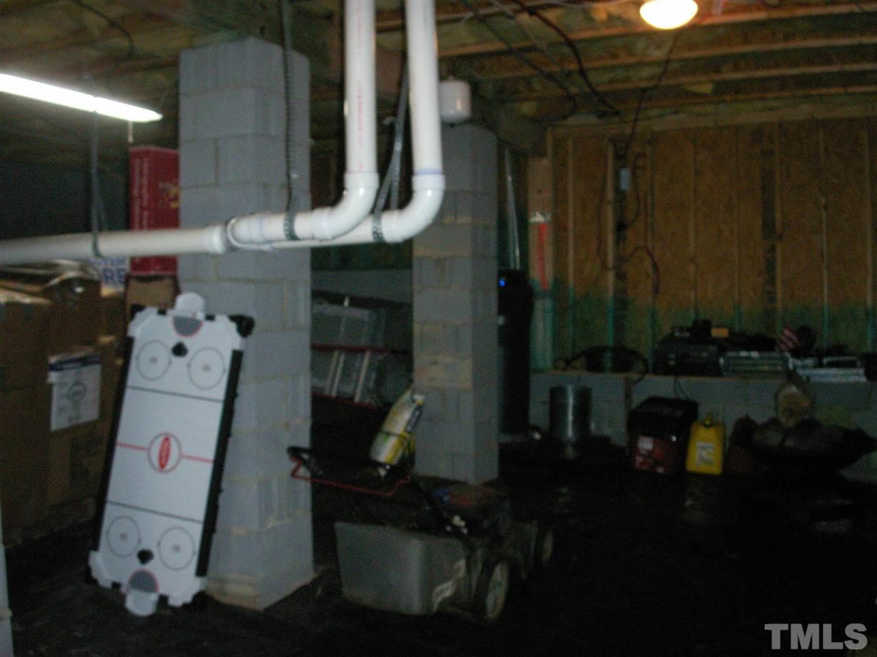 3129 Varcroft Road Knightdale, NC 27545 - Photo 22 of 25 a room with water heater and wooden cabinets