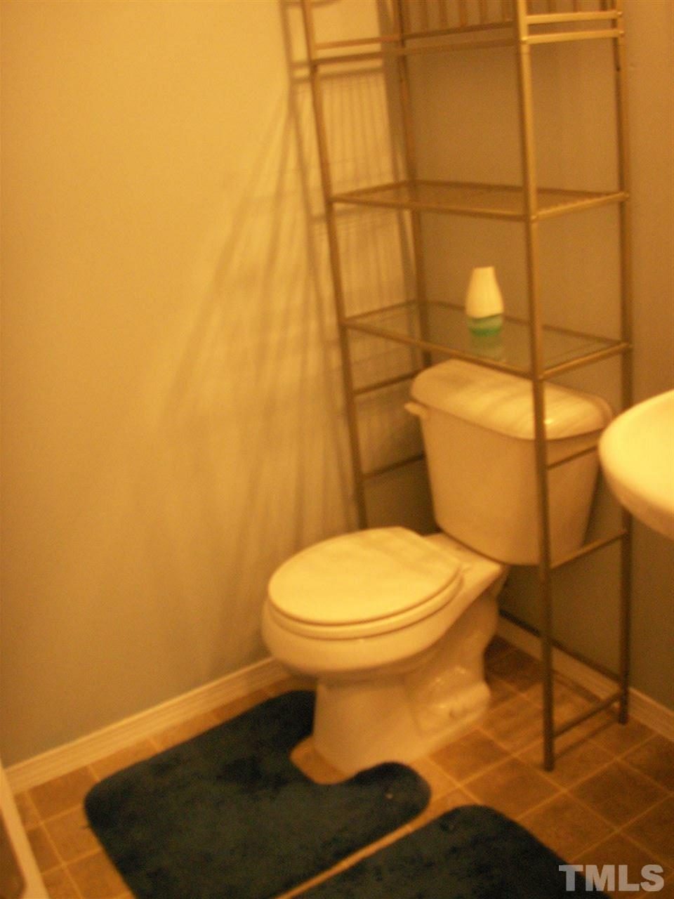 3129 Varcroft Road Knightdale, NC 27545 - Photo 9 of 25 a bathroom with a toilet and a shower