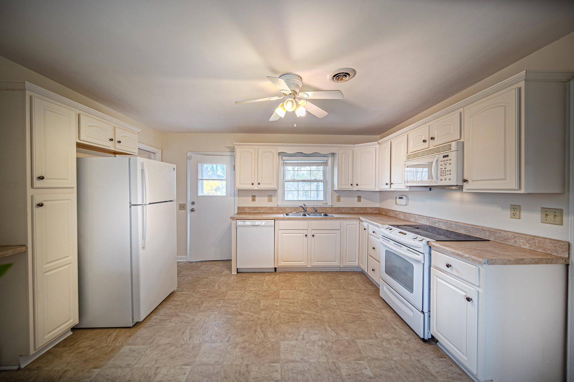 1087 Ross Road Vinton, VA 24179 - Photo 4 of 24 a kitchen with white cabinets and stainless steel appliances