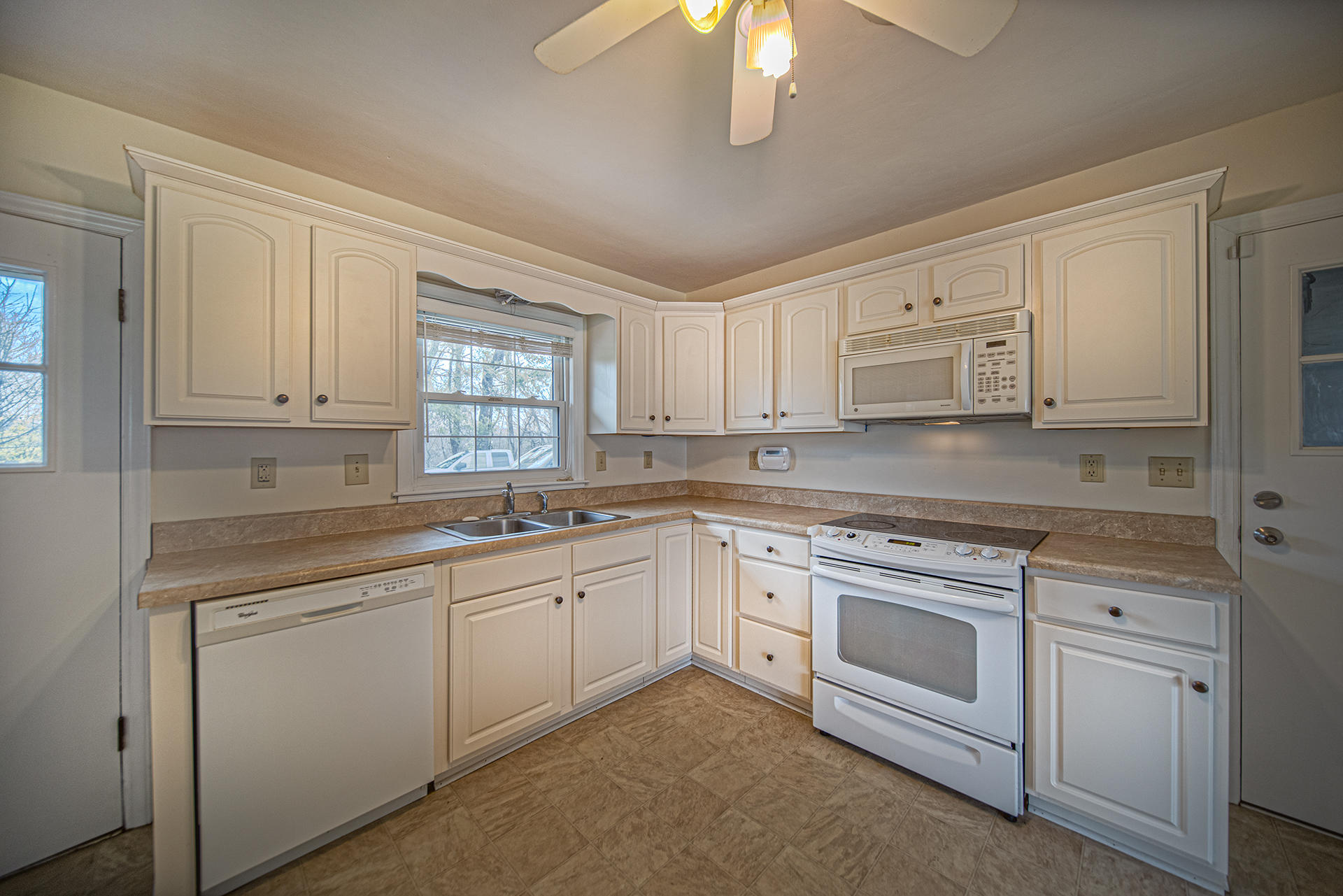1087 Ross Road Vinton, VA 24179 - Photo 5 of 24 a kitchen with white cabinets white appliances and sink