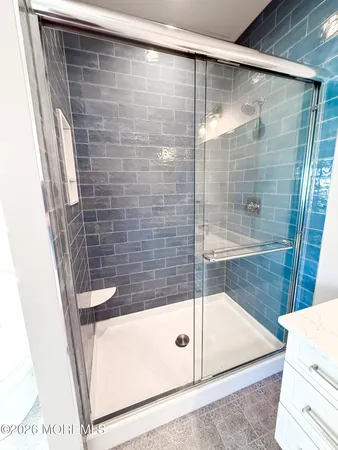 a bathroom with a double vanity sink mirror and toilet