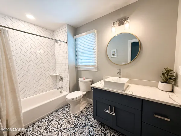 a spacious bedroom with a bed and a couch
