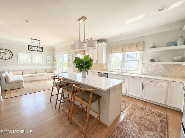 a kitchen with granite countertop white cabinets and appliances