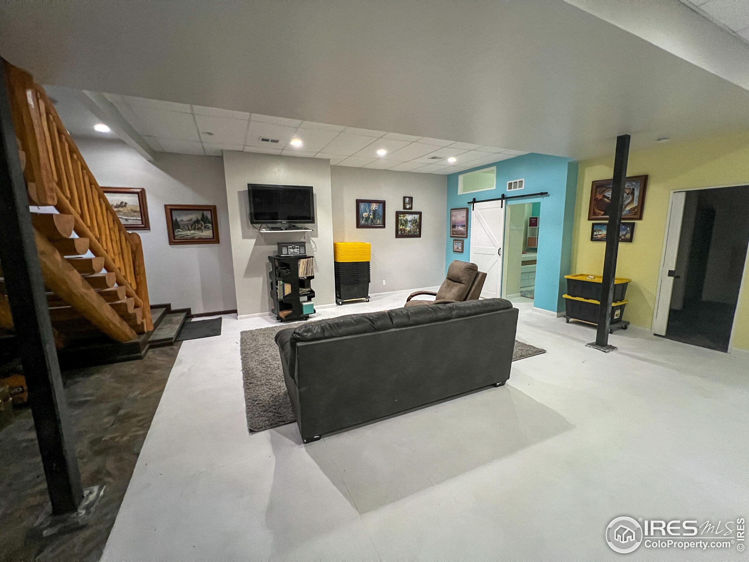 27667 Buckhorn Road Bellvue, CO 80512 - Photo 16 of 40 a living room with furniture and a flat screen tv