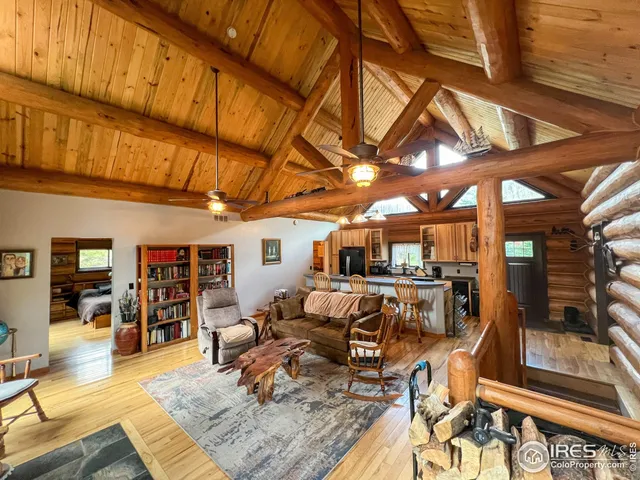 a living room with lots of furniture and kitchen view