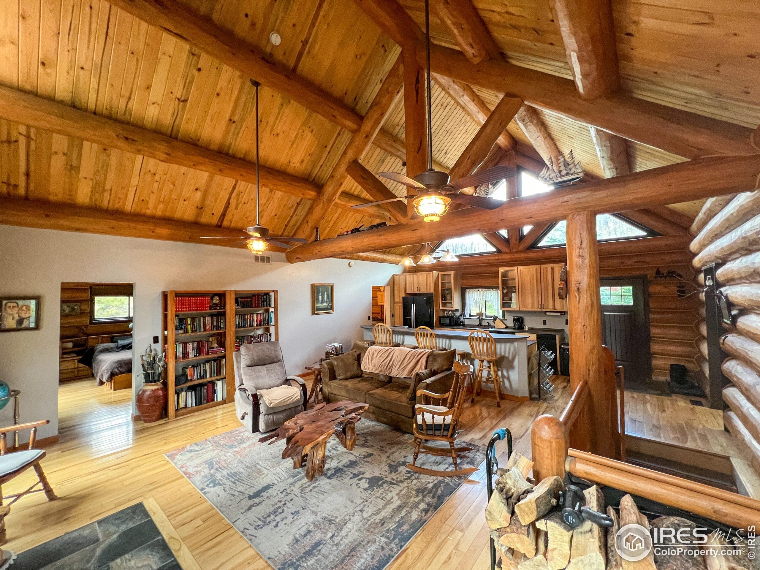 27667 Buckhorn Road Bellvue, CO 80512 - Photo 8 of 40 a living room with lots of furniture and kitchen view