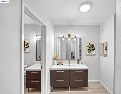 a bathroom with a sink vanity and mirror
