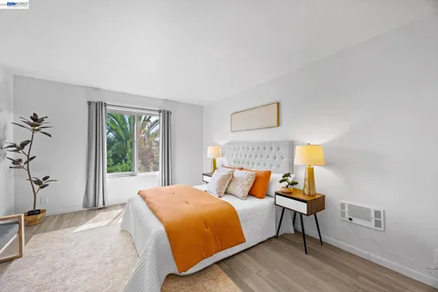 a bedroom with bed and wooden floor