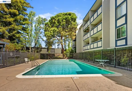 a view of a swimming pool with an outdoor seating and lake view