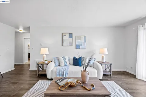 a living room with furniture a rug and a lamp