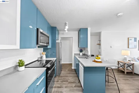 a kitchen with a stove top oven a sink and a counter top space
