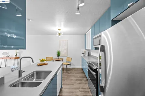 a kitchen with a sink and refrigerator