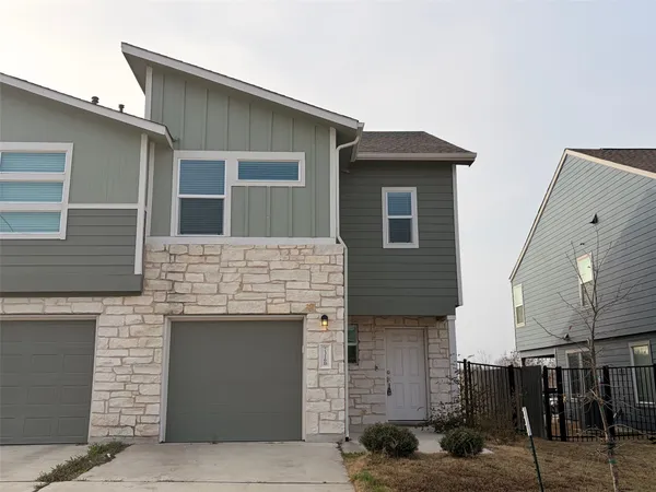 a front view of a house with garage