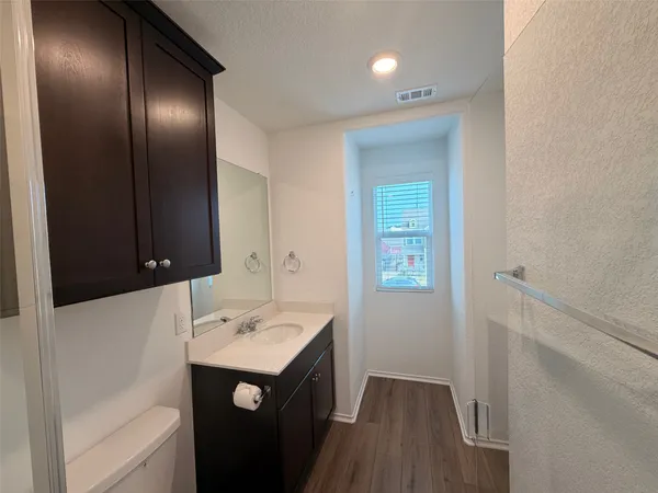 a bathroom with a double vanity sink toilet and shower