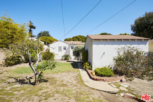 a view of a house with snow on the road