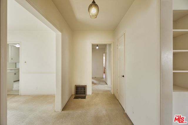 an empty room with windows and entrance