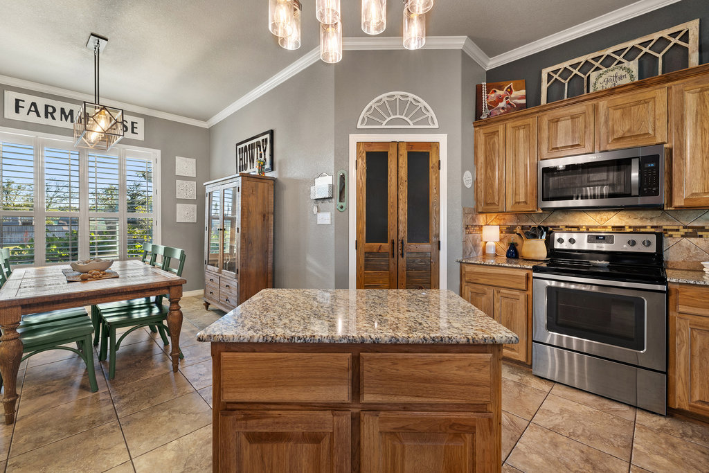 153 Ranger Boulevard Salado, TX 76571 - Photo 11 of 40 a kitchen with stainless steel appliances granite countertop a stove and a refrigerator