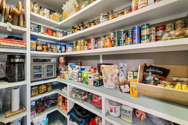 a kitchen with stainless steel appliances granite countertop a refrigerator a stove and a sink