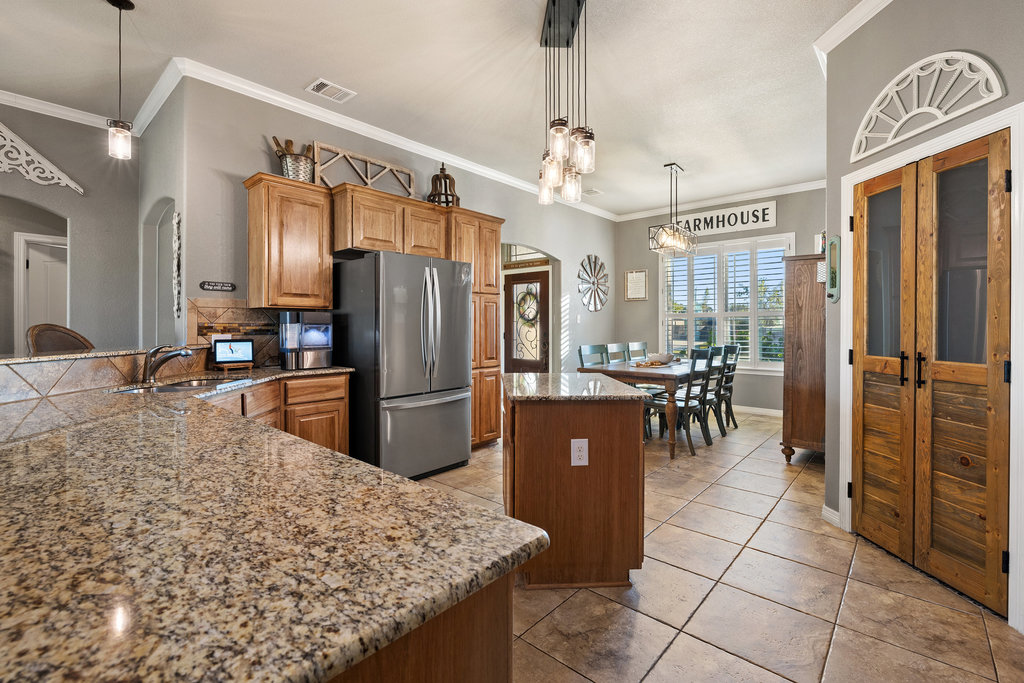 153 Ranger Boulevard Salado, TX 76571 - Photo 13 of 40 a kitchen with stainless steel appliances granite countertop a refrigerator a stove and a sink