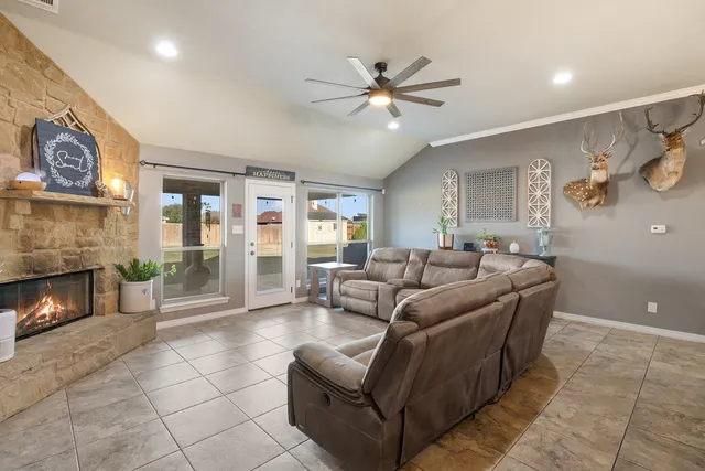 a living room with furniture ceiling fan and a window