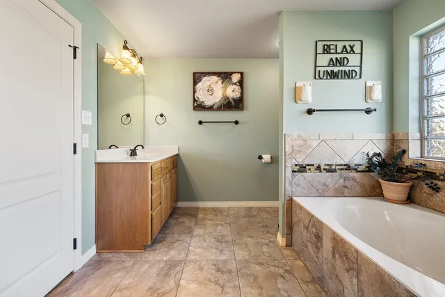 a bathroom with a sink vanity and a mirror