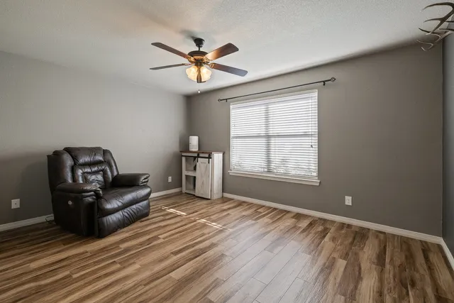 a bedroom with a bed and a large window with the outer view
