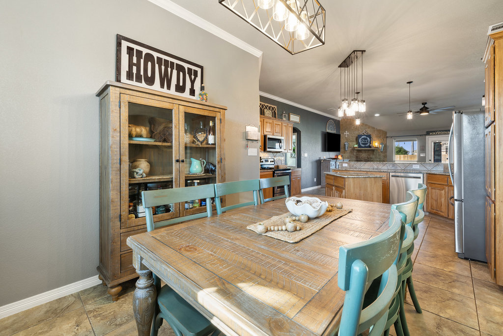 153 Ranger Boulevard Salado, TX 76571 - Photo 8 of 40 a view of a dining room with furniture and a chandelier