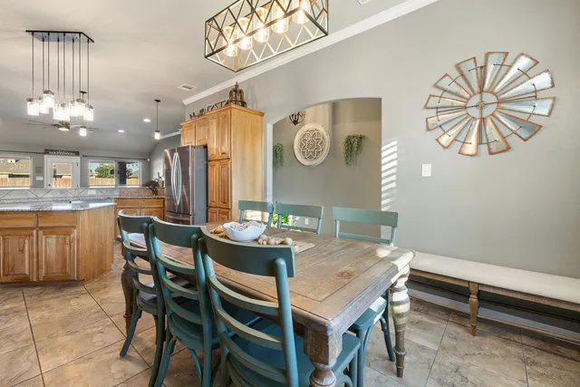 a view of a dining room with furniture and a chandelier