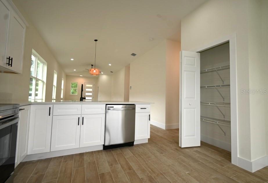 36755 Thomas Jefferson Road Dade City, FL 33525 - Photo 13 of 33 a kitchen with stainless steel appliances a refrigerator sink and cabinets