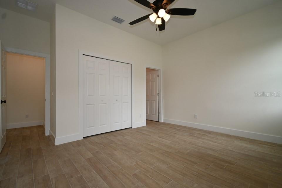 36755 Thomas Jefferson Road Dade City, FL 33525 - Photo 16 of 33 an empty room with a empty space and a ceiling fan