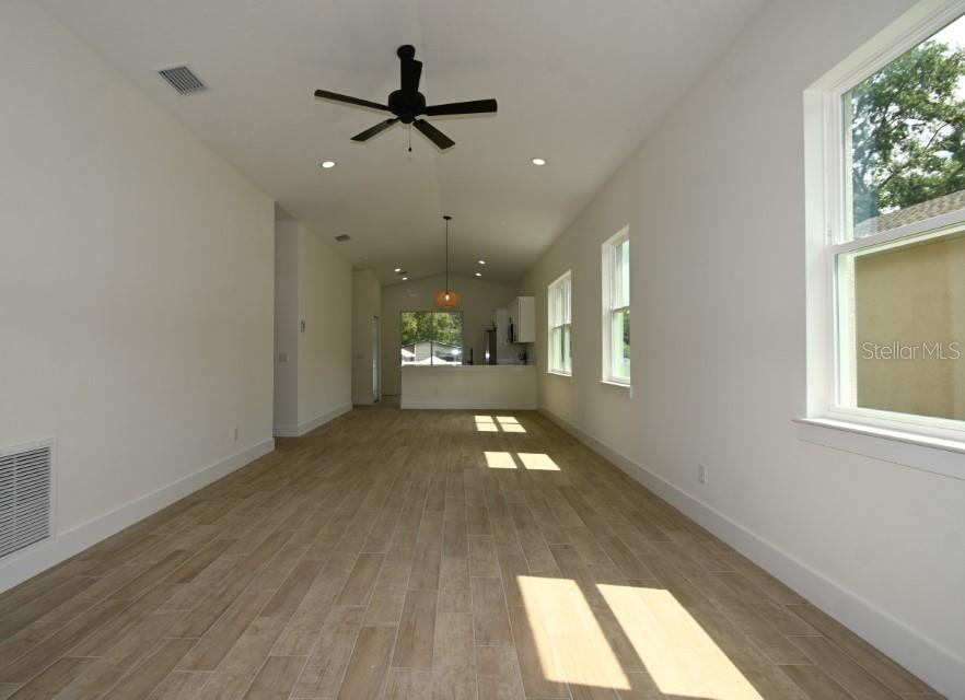 36755 Thomas Jefferson Road Dade City, FL 33525 - Photo 5 of 33 a view of empty room with wooden floor and fan