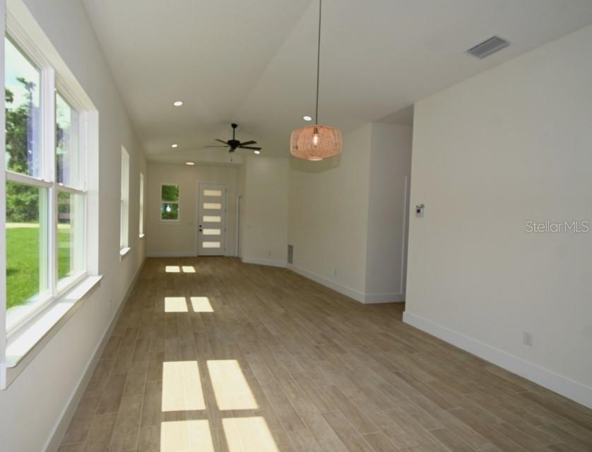 36755 Thomas Jefferson Road Dade City, FL 33525 - Photo 7 of 33 wooden floor in an empty room with a window