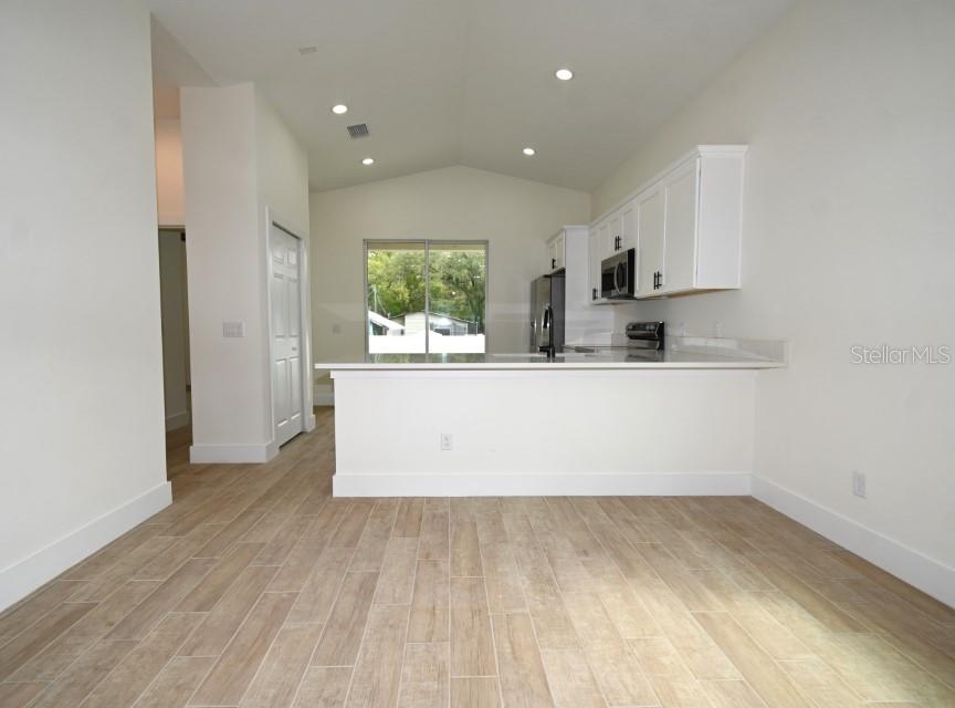 36755 Thomas Jefferson Road Dade City, FL 33525 - Photo 9 of 33 a view of a kitchen with a sink and a refrigerator