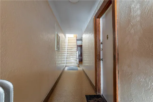 a view of a hallway with windows and stairs