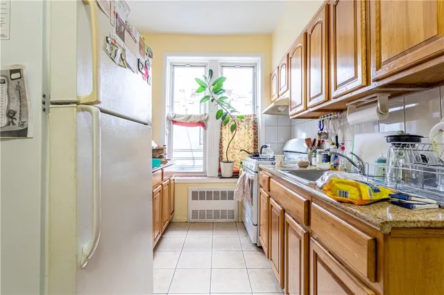 a kitchen with a sink appliances and cabinets