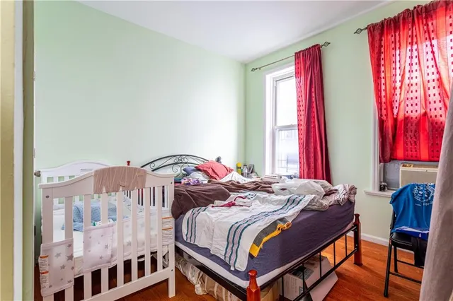 a bedroom with a bed and window