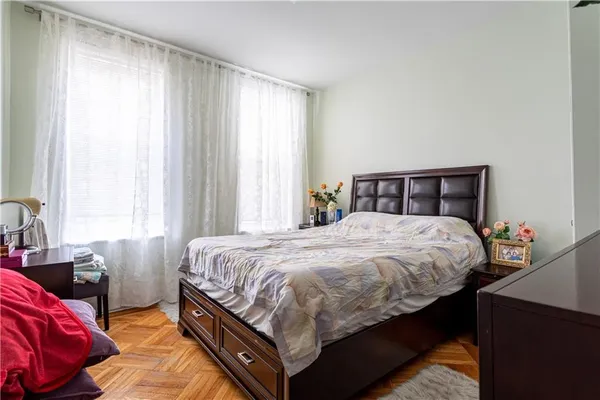 a bedroom with a bed and window
