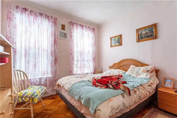 a bedroom with a bed next to a window