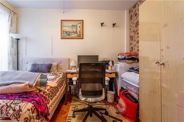 a bed room with a bed and a chair