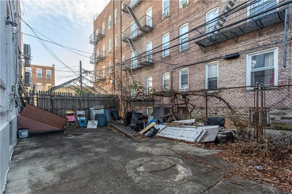 a view of a chairs and table in backyard