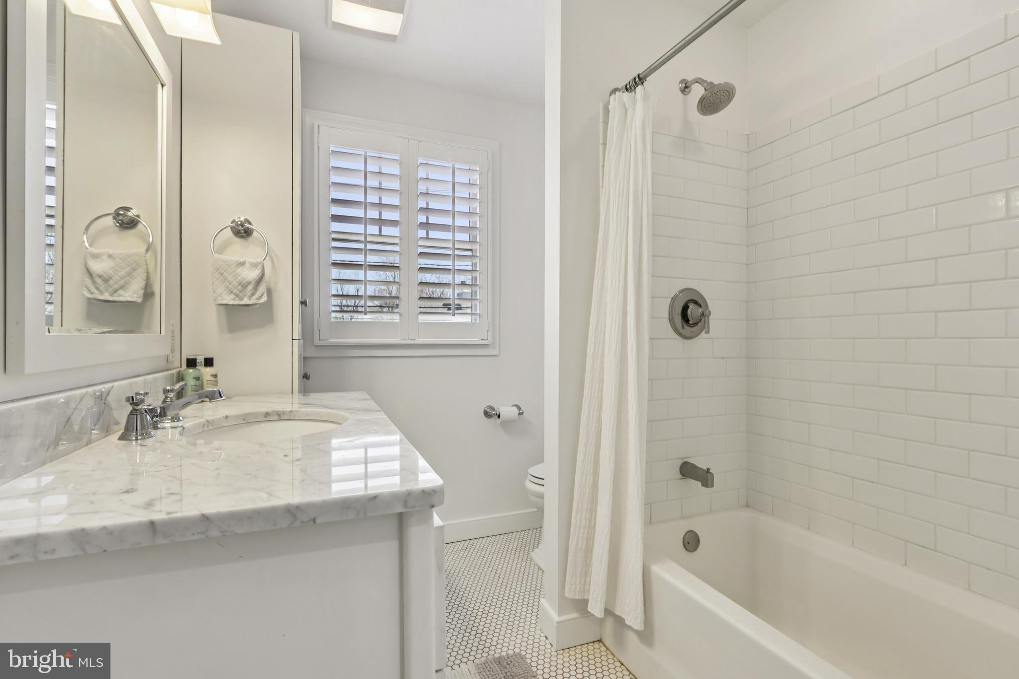 228 South Main Street Pennington, NJ 08534 - Photo 19 of 37 a bathroom with a granite countertop sink a mirror a shower and a bathtub