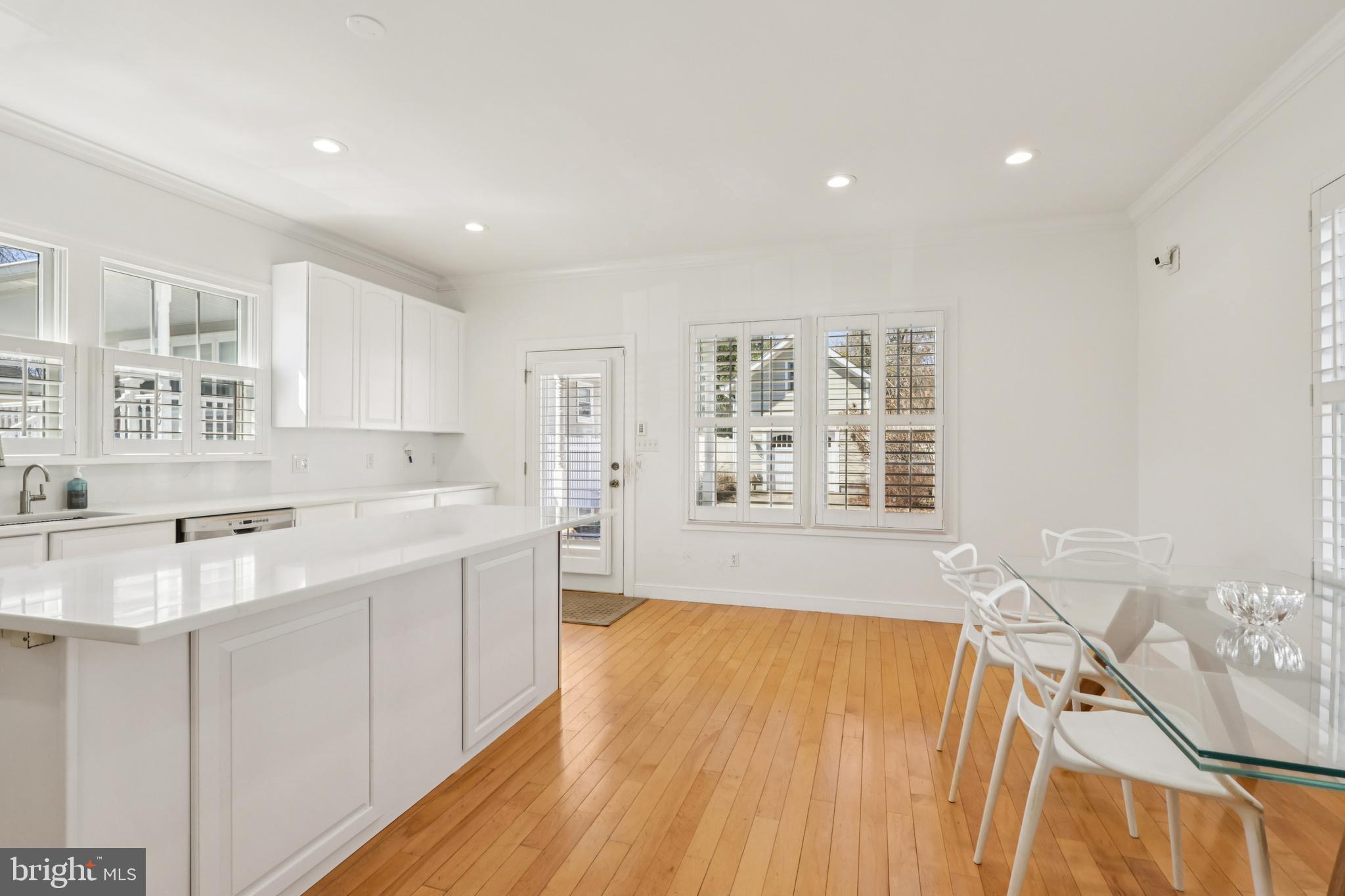 228 South Main Street Pennington, NJ 08534 - Photo 5 of 37 a view of a kitchen with kitchen island a sink wooden floor and counter top space