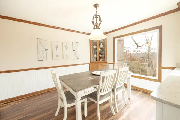 a living room with furniture and a large window with wooden floor