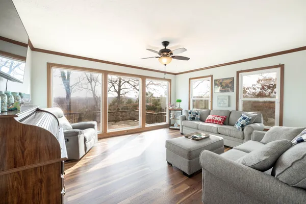 a view of a livingroom with furniture and a ceiling fan
