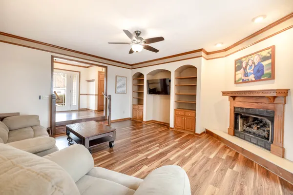 a view of a room with wooden floor and fan
