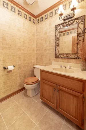 a white toilet sitting next to a bathroom sink