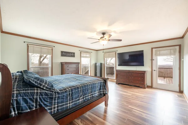 a bedroom with a bed and a chandelier