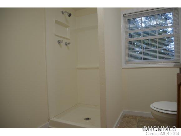 40 Lyle Street Tryon, NC 28782 - Photo 11 of 16 a bathroom with a toilet and a shower