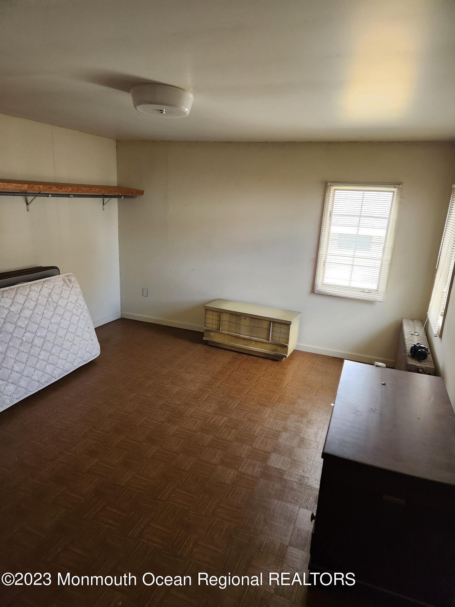 14 Grove Street Long Branch, NJ 07740 - Photo 13 of 21 a view of workspace and bedroom with furniture